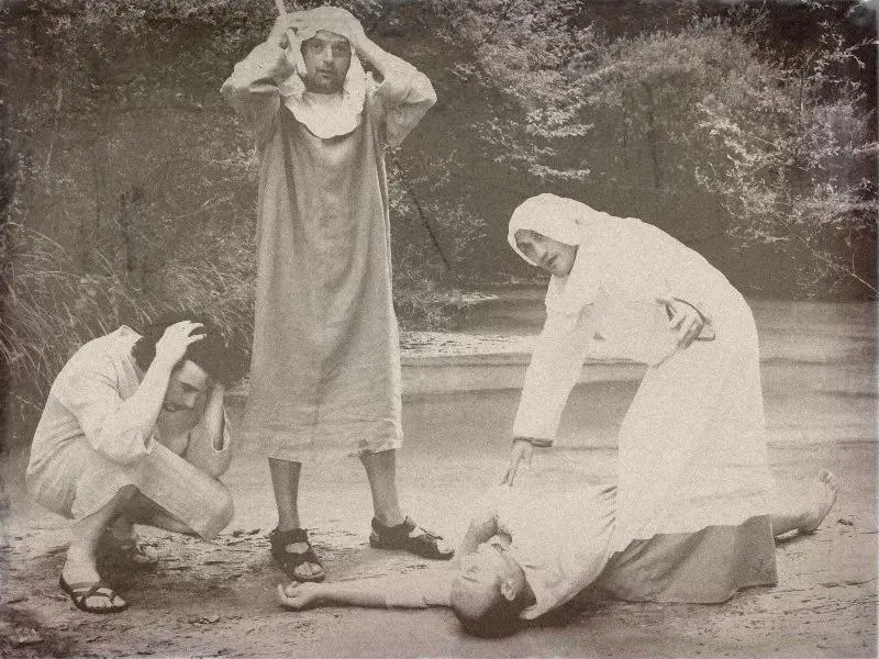 The men gathered around the body — historical reenactment